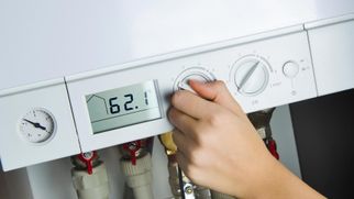 A woman turning a newly installed boiler on