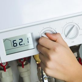 A woman turning a newly installed boiler on